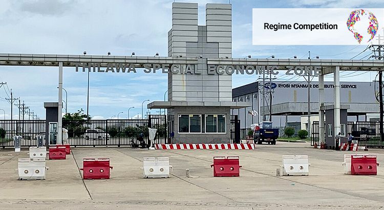 Building with writing "Thilawa Special Economic Zone" that has closed gates and barriers in the driveway