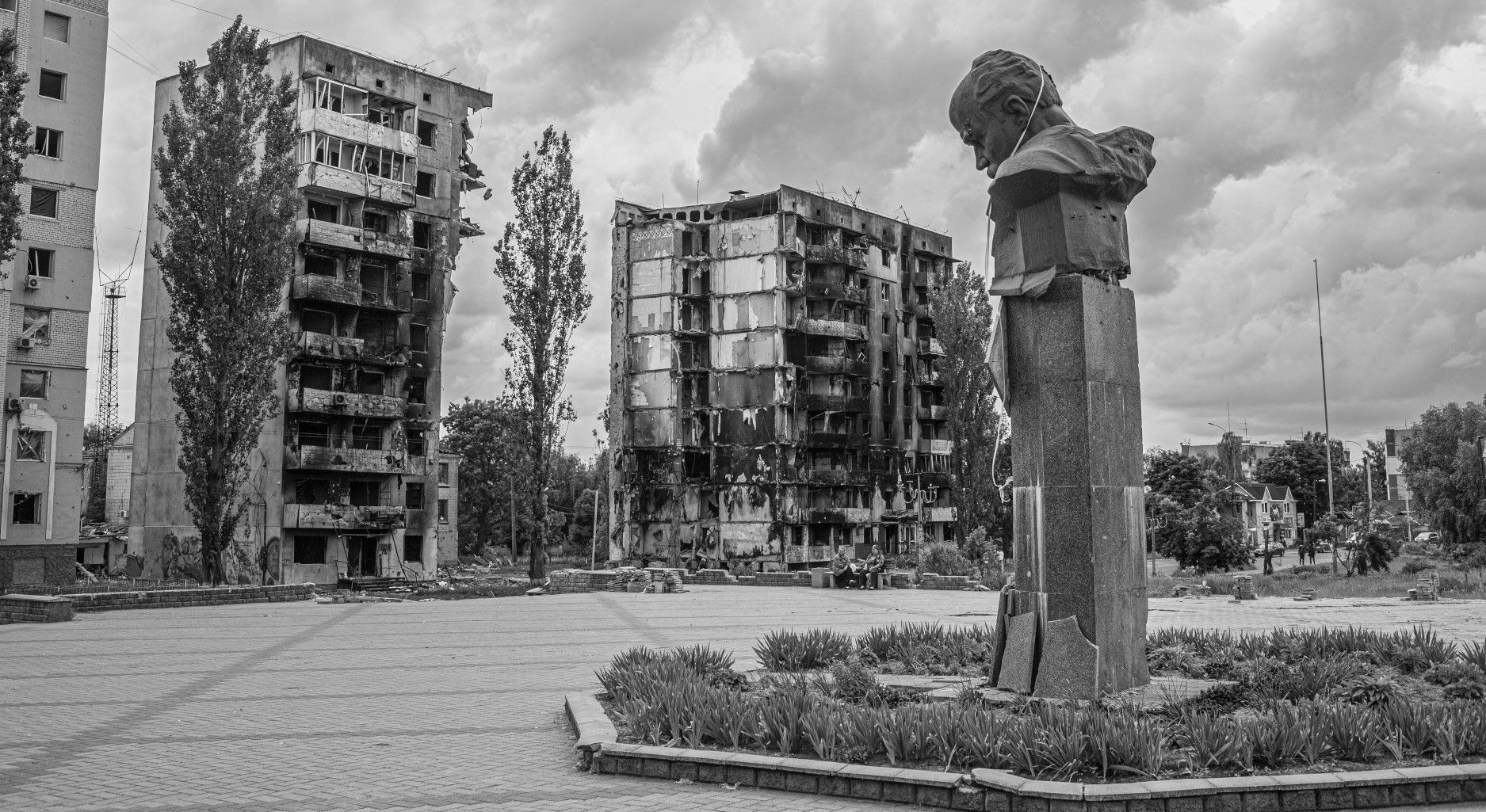 Bombed homes in Borodyanka, Ukraine, and a damaged statue.