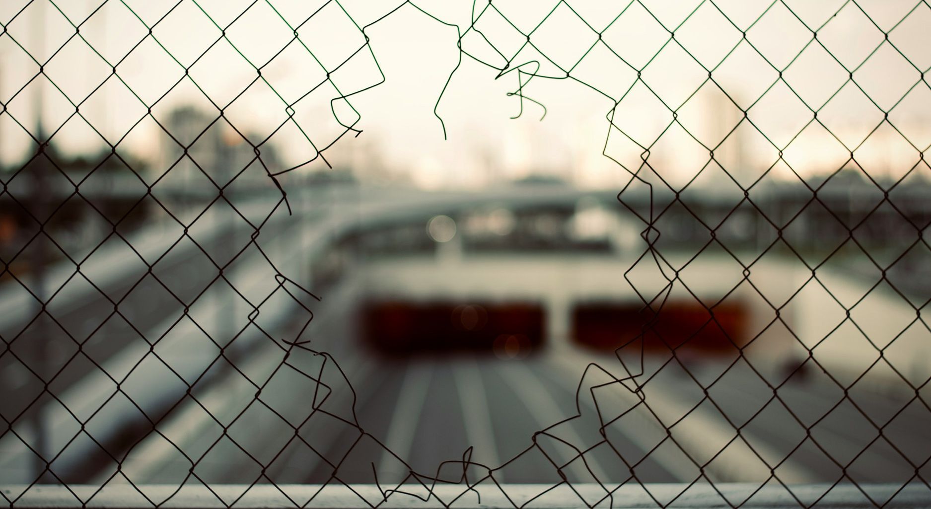 A hole in a wire mesh fence