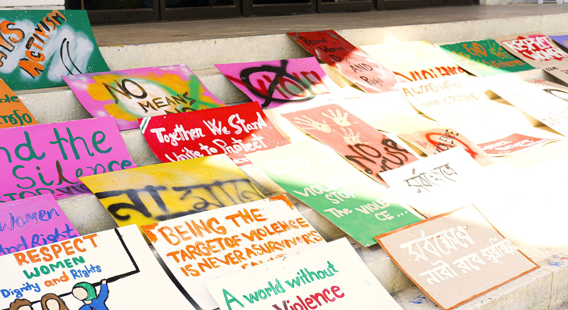 colorful posters and signs protest sexual violence