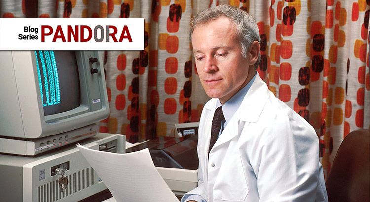 A scientist sitting in front of a computer, looking at datasheets.