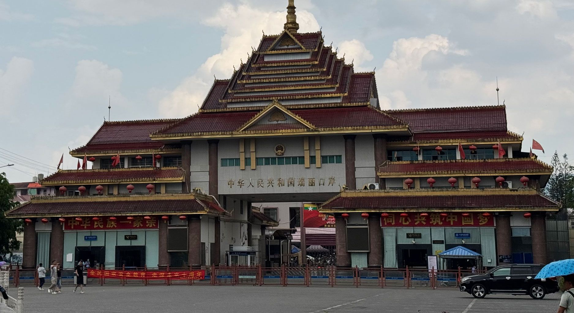 Photo of a big building with chinese signs on it.