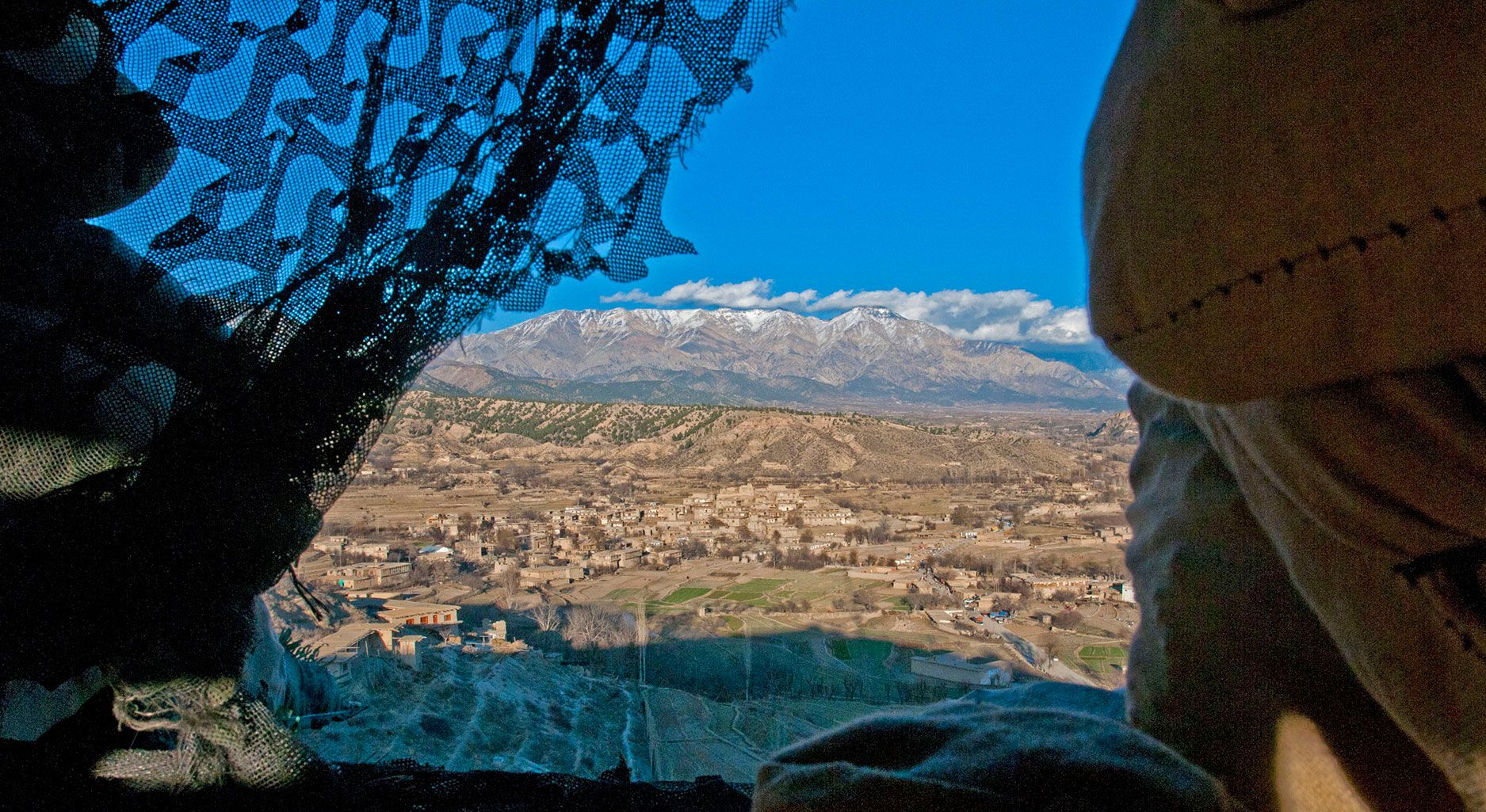 View through a curtain onto a mountainous landscape