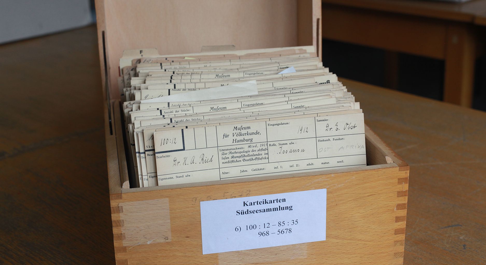 Photo of a wooden box with yellowed index cards
