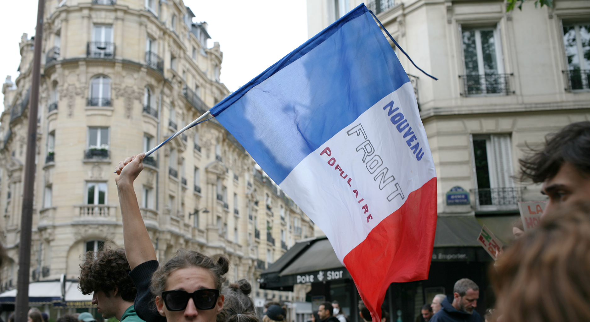 Eine Frankreichfahne mit Aufschrift „Ensemble pour la République“ der vereinigten Linken