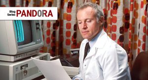 A scientist sitting in front of a computer, looking at datasheets.