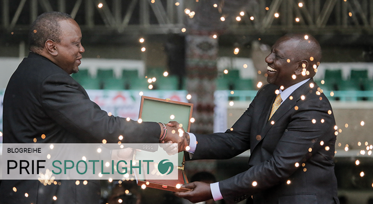 Kenya's new president William Ruto shakes hands with outgoing President Kenyatta, as he is sworn into office. In the other hand, Ruto holds a box. Fireworks can be seen.