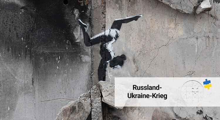 A painting by British street artist Banksy is seen on a building destroyed by fighting in Borodyanka, Kyiv region, Ukraine. The painting shows a woman doing a handstand, apparently on the wreckage.