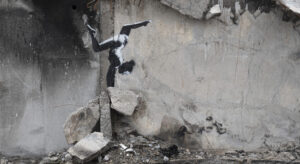 A painting by British street artist Banksy is seen on a building destroyed by fighting in Borodyanka, Kyiv region, Ukraine. The painting shows a woman doing a handstand, apparently on the wreckage.
