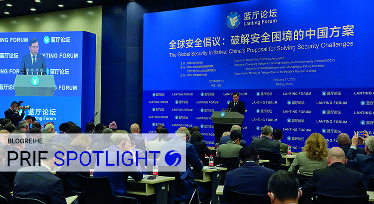 Man standing on a stage in front of an audience. The Wall behind him reads “The Global Security Initiative: Chinas proposal for So...”