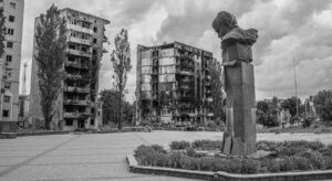 Bombed homes in Borodyanka, Ukraine, and a damaged statue.