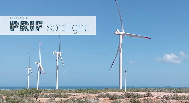 Photograph of a landscape with four wind turbines.