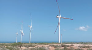 Photograph of a landscape with four wind turbines.