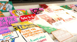 colorful posters and signs protest sexual violence