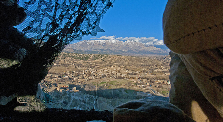 View through a curtain onto a mountainous landscape