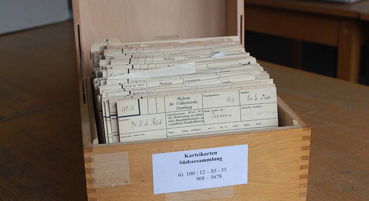 Photo of a wooden box with yellowed index cards