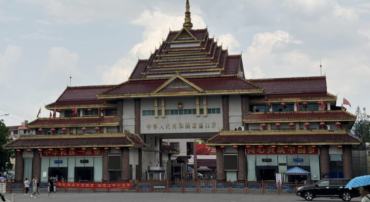 Photo of a big building with chinese signs on it.