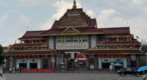 Photo of a big building with chinese signs on it.