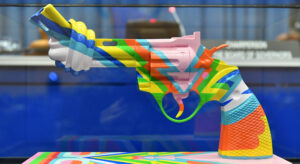 Knotted gun sculpture painted in colorful pattern